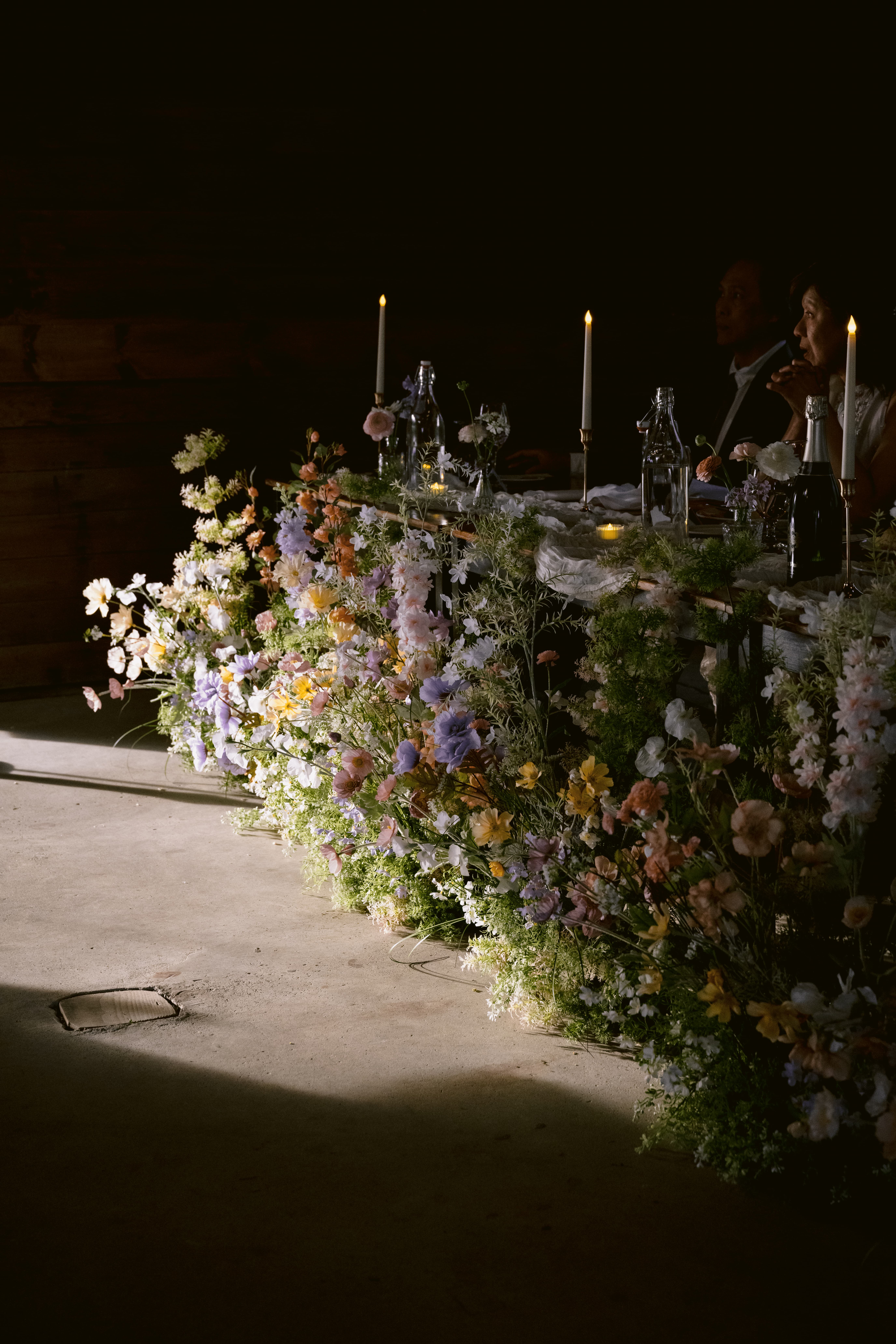 Faux flower aisle markers arranged in a circle around a garden setting
